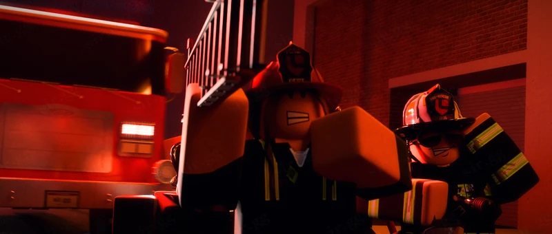 Firefighters lit by orange fire light at night